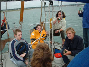 Fellow crew members and family have a few beers at the helm